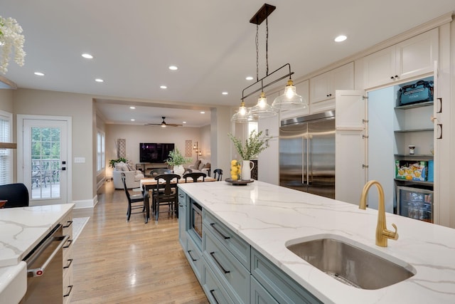 3168 Appian Way, Spring Hill, TN 37174 - kitchen with built in appliances, a sink, beverage cooler, decorative light fixtures, and light wood-style floors