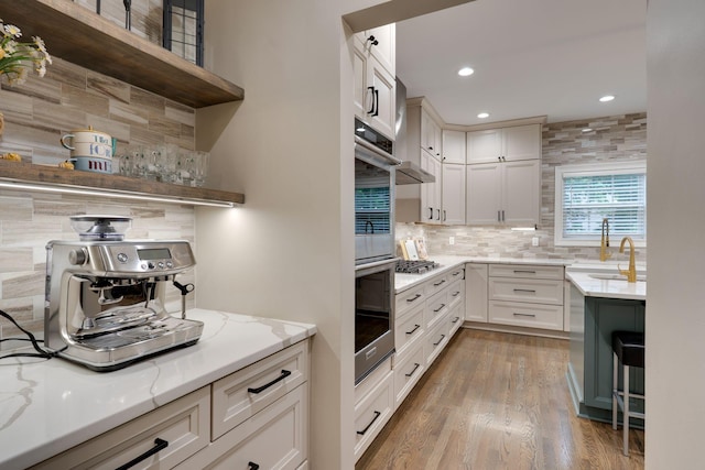 3168 Appian Way, Spring Hill, TN 37174 - kitchen featuring open shelves, decorative backsplash, a sink, light stone countertops, and light wood-type flooring