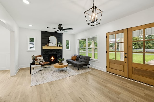 1775 Hayshed Rd, Charlotte, TN 37036 - living area featuring light wood-style flooring, a fireplace, recessed lighting, ceiling fan, and a chandelier