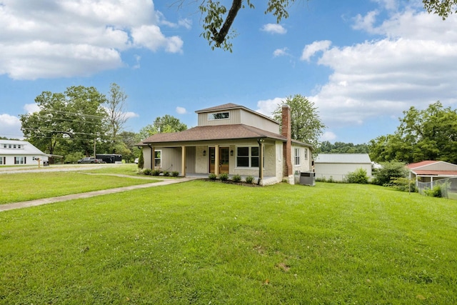 1775 Hayshed Rd, Charlotte, TN 37036 - view of front facade with covered porch, a chimney, and a front lawn