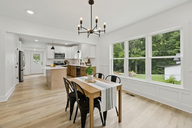 1775 Hayshed Rd, Charlotte, TN 37036 - dining room featuring a chandelier, light wood finished floors, a decorative wall, and recessed lighting