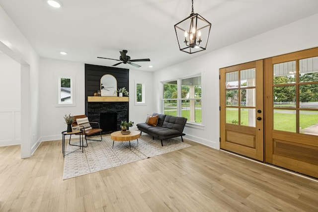 1775 Hayshed Rd, Charlotte, TN 37036 - living area with light wood finished floors, a fireplace, recessed lighting, ceiling fan, and a chandelier