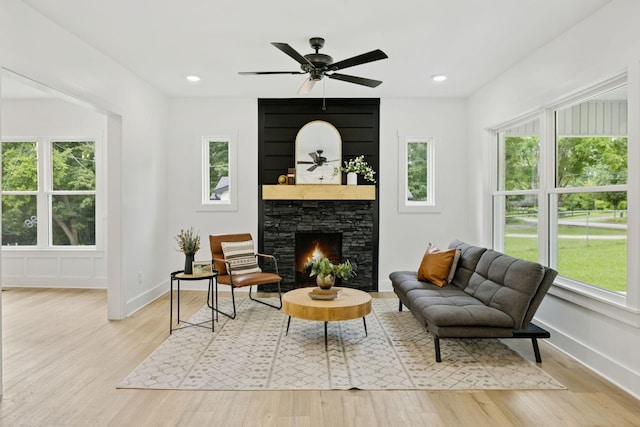 1775 Hayshed Rd, Charlotte, TN 37036 - living room featuring healthy amount of natural light, wood finished floors, a stone fireplace, ceiling fan, and recessed lighting