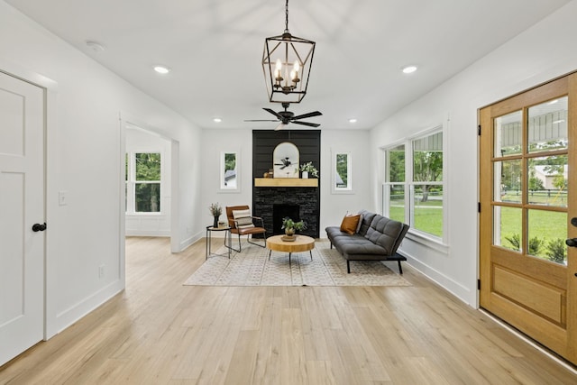 1775 Hayshed Rd, Charlotte, TN 37036 - living area featuring light wood-style flooring, a stone fireplace, healthy amount of natural light, a ceiling fan, and recessed lighting