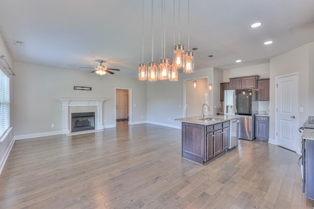 2009 Tulu Ct, Murfreesboro, TN 37128 - kitchen with a sink, appliances with stainless steel finishes, a ceiling fan, light wood-type flooring, and open floor plan