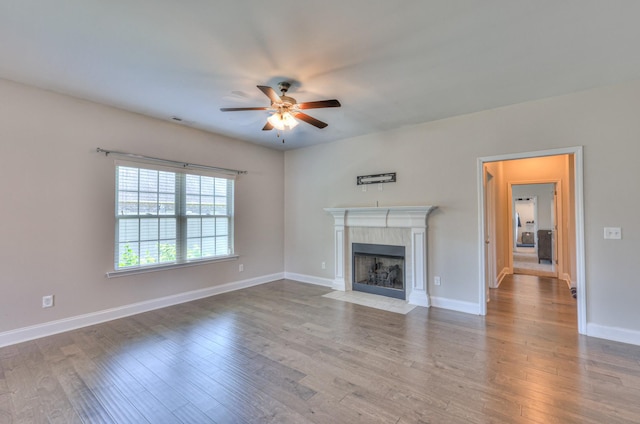2009 Tulu Ct, Murfreesboro, TN 37128 - unfurnished living room featuring a ceiling fan, a tile fireplace, wood finished floors, and baseboards
