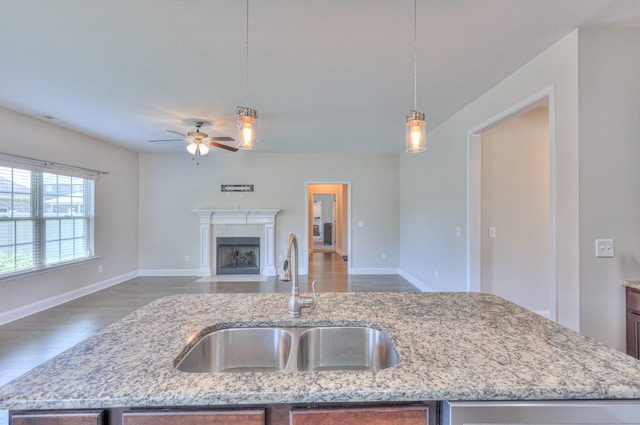 2009 Tulu Ct, Murfreesboro, TN 37128 - kitchen with a sink, open floor plan, ceiling fan, wood finished floors, and light stone countertops