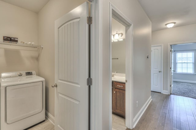 2009 Tulu Ct, Murfreesboro, TN 37128 - laundry room with washer / clothes dryer, baseboards, and light wood-style floors