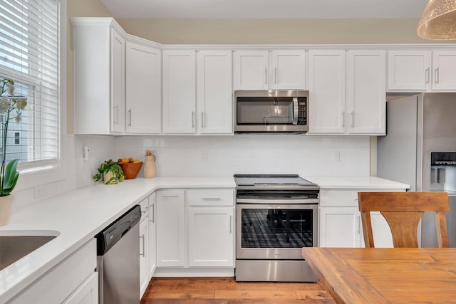 500 Creative Way Unit 16, Madison, TN 37115 - kitchen with stainless steel appliances, white cabinets, backsplash, light wood-style floors, and wood counters