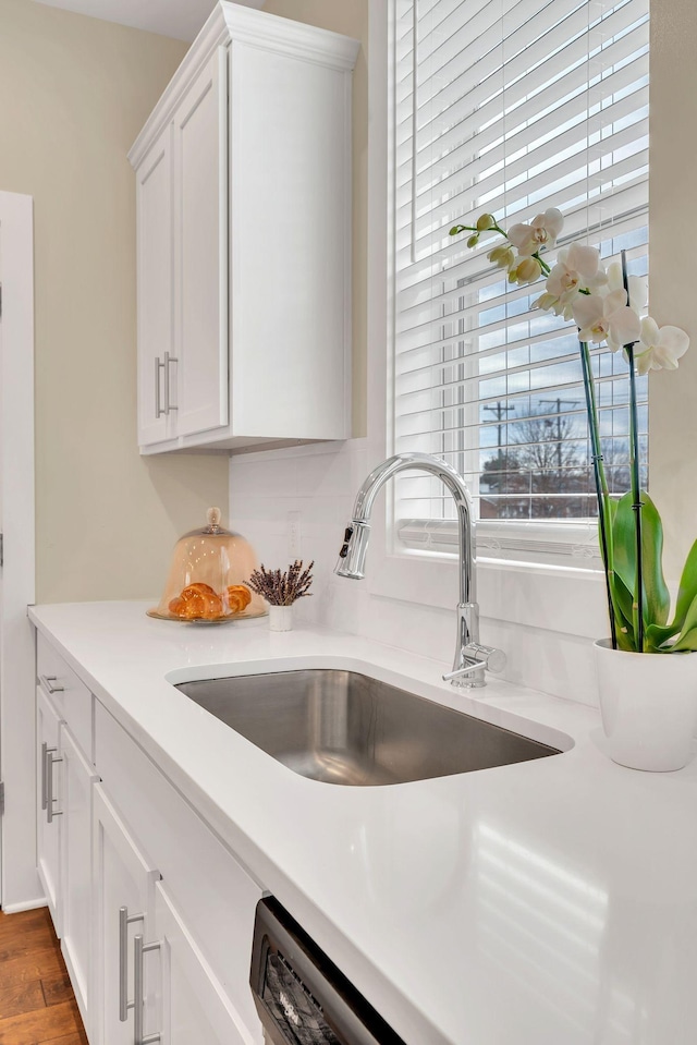 500 Creative Way Unit 16, Madison, TN 37115 - kitchen view of a sink, white cabinetry, light countertops, and wood finished floors