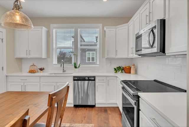 500 Creative Way Unit 16, Madison, TN 37115 - kitchen with stainless steel appliances, a sink, white cabinets, light wood-style floors, and light countertops