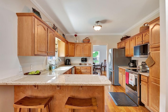 2710 Maylon Dr, Murfreesboro, TN 37128 - kitchen with stainless steel appliances, a peninsula, light wood-style flooring, a breakfast bar, and crown molding