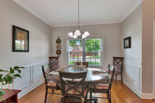 2710 Maylon Dr, Murfreesboro, TN 37128 - dining space with a chandelier, light wood-type flooring, crown molding, a decorative wall, and wainscoting