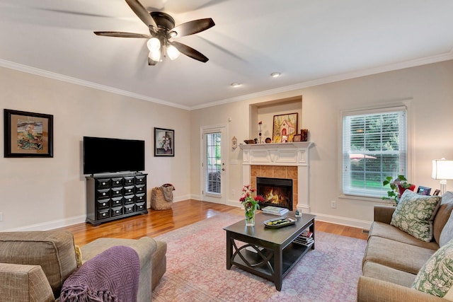 2710 Maylon Dr, Murfreesboro, TN 37128 - living room featuring wood finished floors, healthy amount of natural light, ornamental molding, ceiling fan, and a fireplace