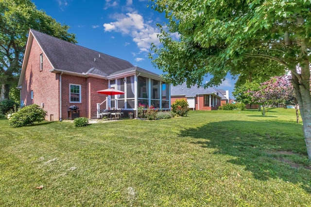 2710 Maylon Dr, Murfreesboro, TN 37128 - back of property with a sunroom, brick siding, a shingled roof, and a yard