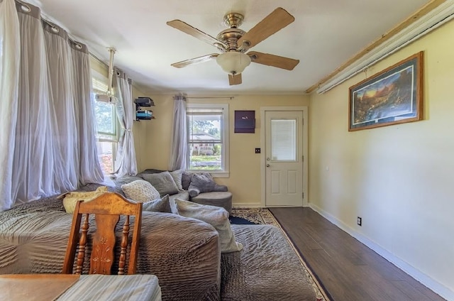155 Thomas St, Savannah, TN 38372 - living room featuring dark wood-style floors, a ceiling fan, baseboards, and ornamental molding