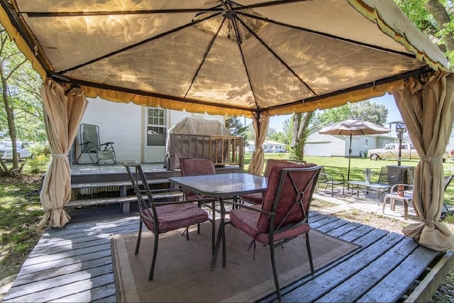 155 Thomas St, Savannah, TN 38372 - deck with a gazebo, outdoor dining area, and a yard