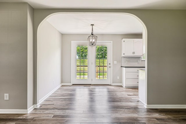 710 Krissy Ct, Columbia, TN 38401 - unfurnished dining area featuring arched walkways, dark wood finished floors, and baseboards