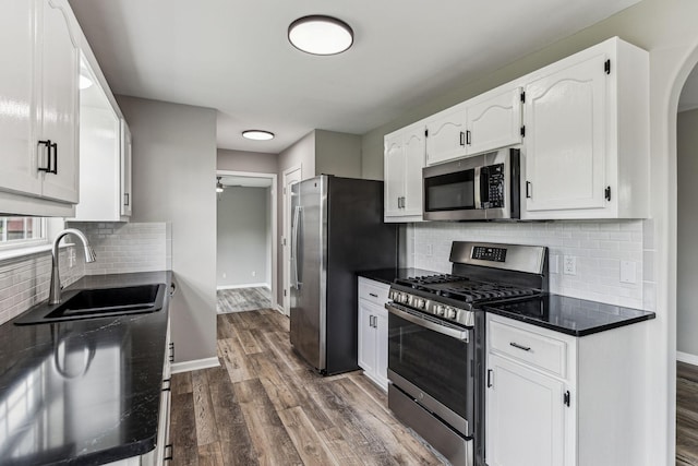 710 Krissy Ct, Columbia, TN 38401 - kitchen featuring appliances with stainless steel finishes, a sink, dark countertops, dark wood finished floors, and white cabinets