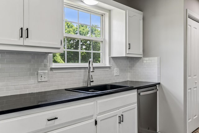 710 Krissy Ct, Columbia, TN 38401 - kitchen featuring dishwasher, a sink, dark countertops, and white cabinetry
