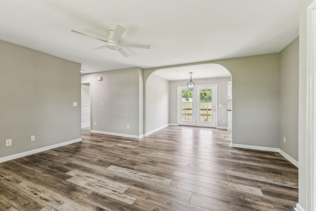 710 Krissy Ct, Columbia, TN 38401 - spare room featuring arched walkways, ceiling fan, dark wood finished floors, baseboards, and a chandelier
