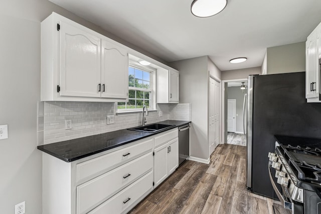 710 Krissy Ct, Columbia, TN 38401 - kitchen featuring a sink, stainless steel appliances, dark countertops, tasteful backsplash, and white cabinetry