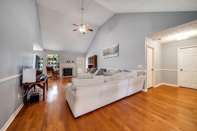 152 Cody Ct, Portland, TN 37148 - living room with high vaulted ceiling, ceiling fan, light wood-style flooring, a fireplace, and baseboards