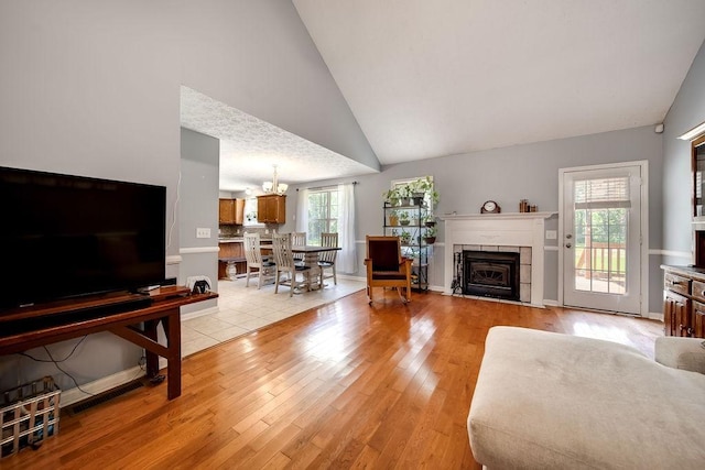 152 Cody Ct, Portland, TN 37148 - living area with a tiled fireplace, lofted ceiling, and light wood-style flooring