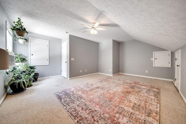 152 Cody Ct, Portland, TN 37148 - unfurnished living room featuring light carpet, a ceiling fan, lofted ceiling, a textured ceiling, and baseboards