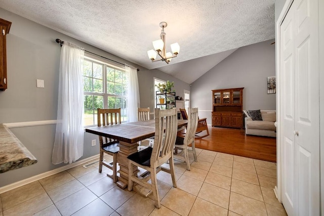 152 Cody Ct, Portland, TN 37148 - dining space with a chandelier, light tile patterned flooring, baseboards, a textured ceiling, and vaulted ceiling