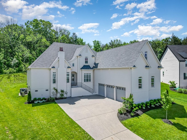 2036 Bocage Cir, Nolensville, TN 37135 - french country inspired facade featuring stucco siding, driveway, a front yard, and an attached garage