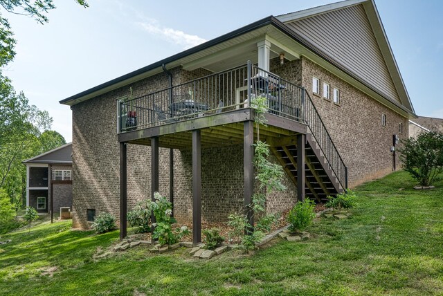 1124 Cross Pointe Dr, Cookeville, TN 38506 - view of side of property with brick siding, a lawn, a wooden deck, and stairway