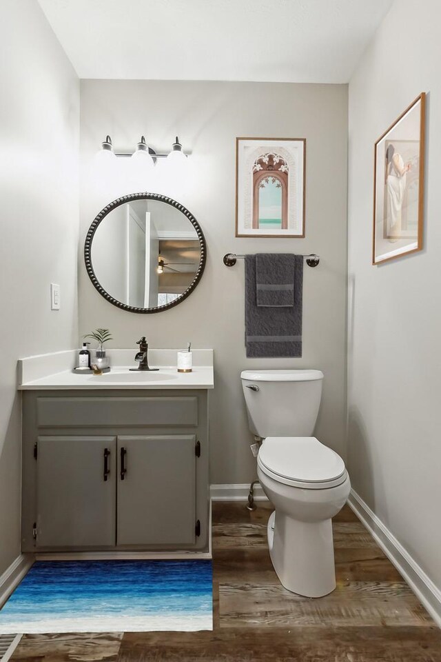 2640 Queen Anne Ct, Springfield, TN 37172 - half bathroom with vanity, wood finished floors, baseboards, toilet, and a ceiling fan