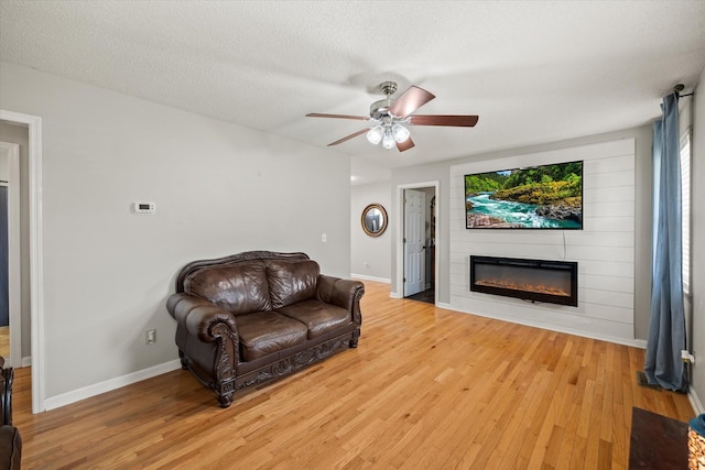 3571 Southmeade Dr, Cookeville, TN 38506 - living area with a fireplace, light wood finished floors, a ceiling fan, and baseboards