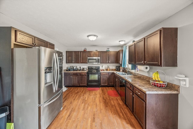 1531 Lake Villa Cir, Cookeville, TN 38506 - kitchen with black appliances, a sink, light wood-style floors, and dark brown cabinets