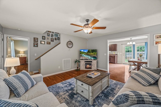 1531 Lake Villa Cir, Cookeville, TN 38506 - living area featuring dark wood-style flooring, baseboards, a ceiling fan, and stairs