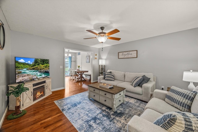 1531 Lake Villa Cir, Cookeville, TN 38506 - living area with a ceiling fan, dark wood-style flooring, a lit fireplace, and baseboards
