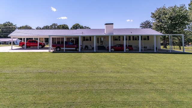 1448 Baker Ln, Lawrenceburg, TN 38464 - rear view of property featuring a carport, a yard, a chimney, and metal roof
