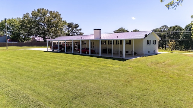 1448 Baker Ln, Lawrenceburg, TN 38464 - back of property with a patio, a chimney, and metal roof