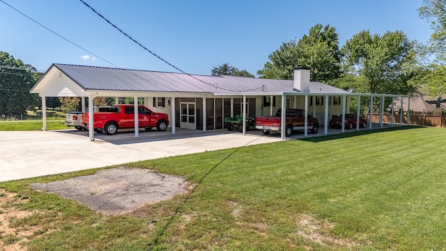 1448 Baker Ln, Lawrenceburg, TN 38464 - view of front facade featuring an attached carport, a chimney, concrete driveway, and metal roof