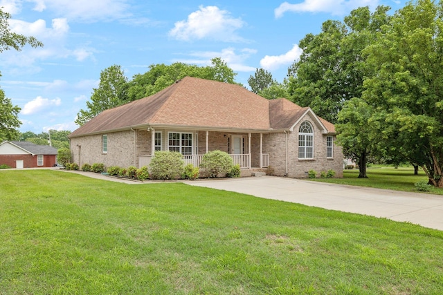 1075 Kathryn Rd, Mount Juliet, TN 37122 - view of front of home with a porch, brick siding, a front yard, and roof with shingles
