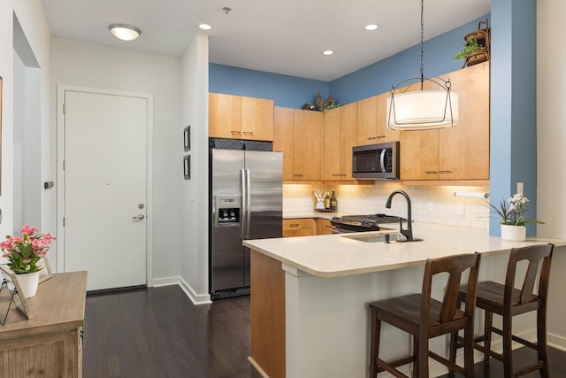 200 Manufacturers Rd Apt 241, Chattanooga, TN 37405 - kitchen with stainless steel appliances, a sink, a peninsula, dark wood-style flooring, and light countertops