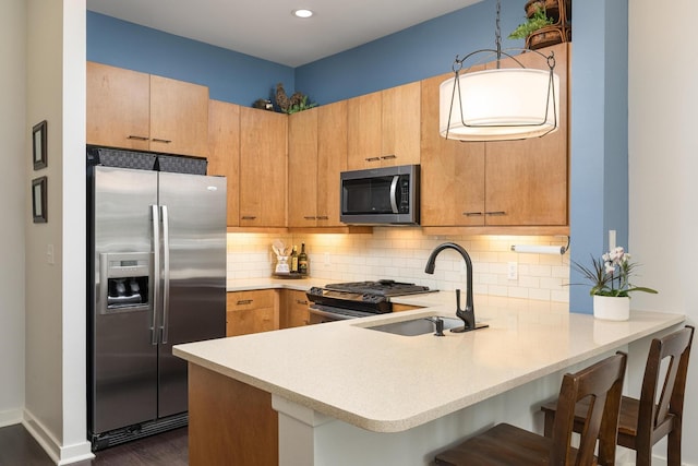 200 Manufacturers Rd Apt 241, Chattanooga, TN 37405 - kitchen with appliances with stainless steel finishes, a peninsula, light countertops, a sink, and tasteful backsplash