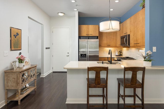 200 Manufacturers Rd Apt 241, Chattanooga, TN 37405 - kitchen with stainless steel appliances, a sink, light countertops, brown cabinets, and a peninsula