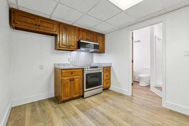 5430 Stacy Springs Rd, Springfield, TN 37172 - kitchen featuring appliances with stainless steel finishes, light wood-type flooring, brown cabinets, and a paneled ceiling