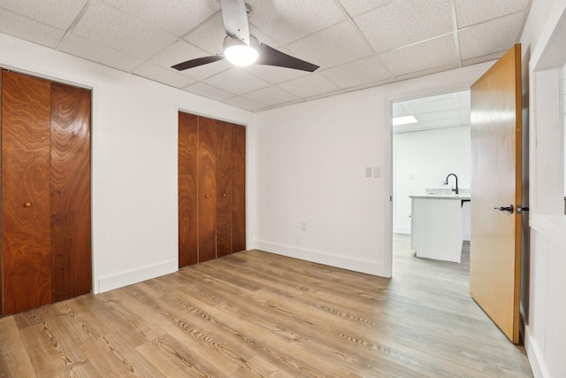 5430 Stacy Springs Rd, Springfield, TN 37172 - unfurnished bedroom featuring light wood-style flooring, a paneled ceiling, ceiling fan, a sink, and baseboards
