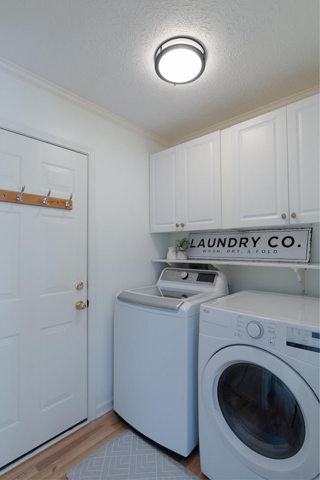 405 Parish Pl, Franklin, TN 37067 - washroom featuring cabinet space, independent washer and dryer, ornamental molding, light wood-style floors, and a textured ceiling