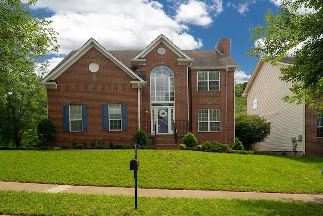 405 Parish Pl, Franklin, TN 37067 - traditional-style home featuring a chimney, brick siding, and a front lawn
