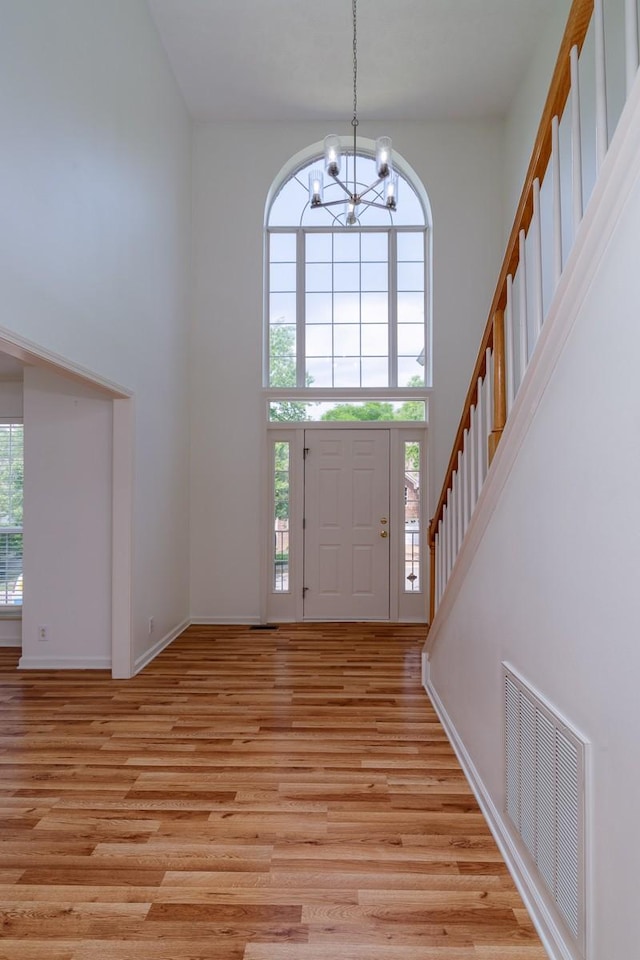 405 Parish Pl, Franklin, TN 37067 - entrance foyer featuring a towering ceiling, a chandelier, light wood finished floors, baseboards, and stairway