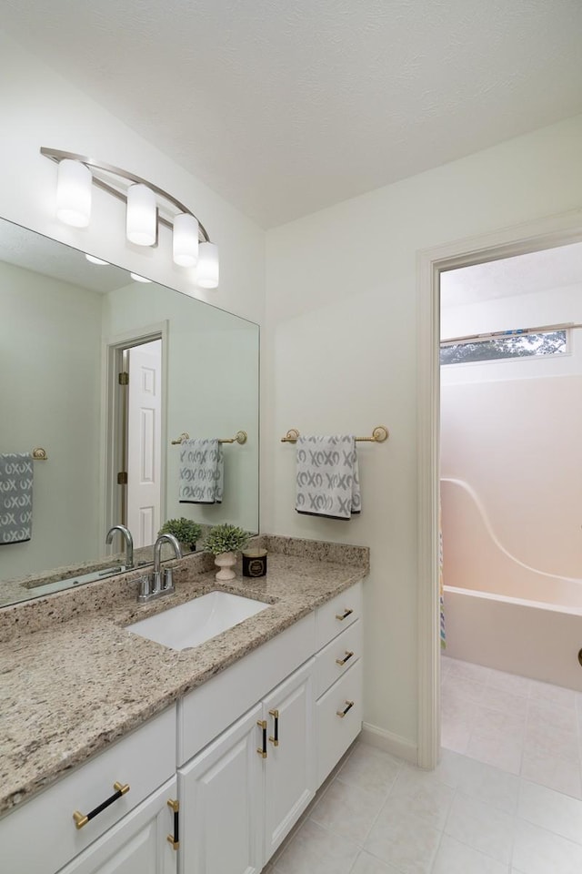 405 Parish Pl, Franklin, TN 37067 - bathroom featuring vanity, a bath, tile patterned floors, and baseboards